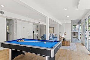 Ground floor living space. Billiard table with sofa area in background.