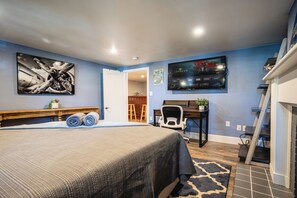 Featuring the desk, TV and connecting living room. Left is a walk-in closet &W/D