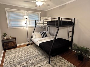 Bunk bedroom with full bed at the bottom, twin bed at the top and twin trundle