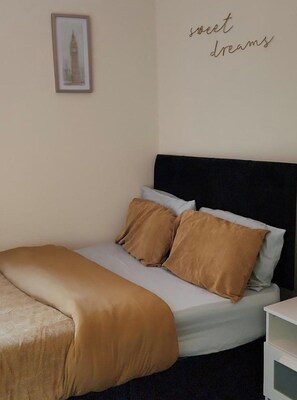 A well laid beautiful double bed and a spacious room