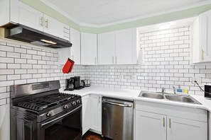 Cook up a storm in this fully equipped, modern kitchen, featuring sleek stainless-steel appliances, ample counter space, and all the essentials you need for a perfect meal!