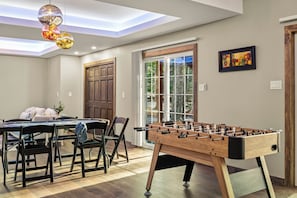 Game room with foosball and a card table.
