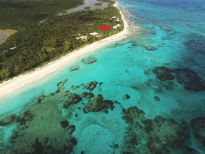 Double Bay Beach is a spectacular 2-mile-long beach protected by a barrier reef, which keeps the surf down.  The red arrow points to Veselka House.