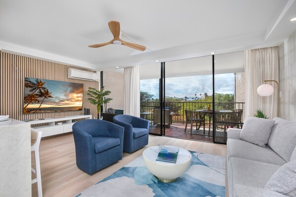 Living room with 75" flatscreen TV and split AC