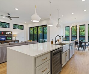 Designed for togetherness, this space connects the kitchen, dining, and living areas in perfect harmony. High ceilings enhance the airy feel, making it perfect for gatherings and easy conversations.