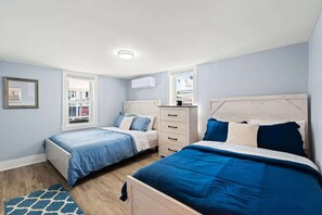 Perfect for families or friends, this spacious room features both a full and queen bed for a comfortable stay.