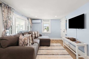 Enjoy the open and inviting living space with comfortable seating and entertainment at your fingertips.