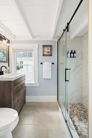 Elegant bathroom featuring a walk-in shower with modern fixtures, designed for ultimate comfort and relaxation.