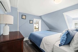 Spacious bedroom with a comfortable queen bed and stunning ocean views, perfect for a serene and relaxing getaway.