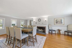 Host elegant dinners in the dining room, featuring a large table with seating for eight and a beautiful fireplace.