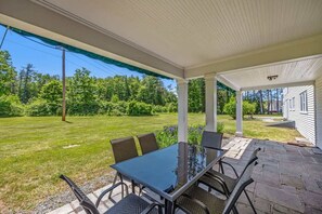 Enjoy al fresco dining on the spacious patio, surrounded by beautiful landscaping and plenty of room for outdoor activities.