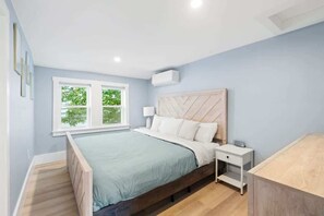 Unwind in the elegant master bedroom with a plush king bed, tasteful decor, and plenty of storage in the bureau.