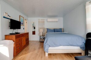 Unwind in coastal comfort with a plush queen bed, a cozy bureau for storage, and a TV for your entertainment—your perfect beachside escape.