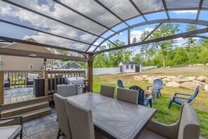Dine and relax in our outdoor oasis, featuring a covered patio, propane grill, and spacious backyard with a fire pit. Perfect for family gatherings or enjoying the peaceful surroundings.
