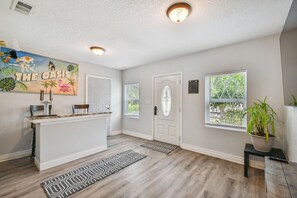 Welcoming game room with darts and bar by the entrance
