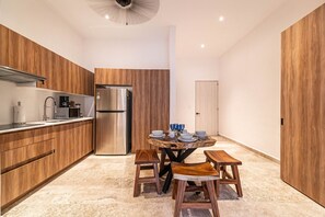 Gather around the cozy dining table, perfect for enjoying meals or planning your adventures.