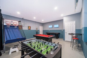 Game room with Pool Table, Fooseball, Air Hockey, Basketball and two TV's.