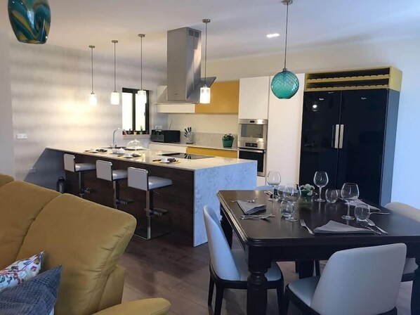 Large and fully equipped kitchen with fridge, freezer, toaster, oven , microwave oven, dishwasher and coffee machine. 