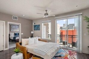 Beautifully designed living room. 75" TV, leather sleeper sofa and amazing views of mountains and city skyline.