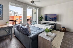 Beautifully designed living room. 75" TV, Queen sleeper sofa and amazing views of mountains and city skyline.
