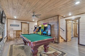 Fun-filled game room with pool table and arcade classics.
