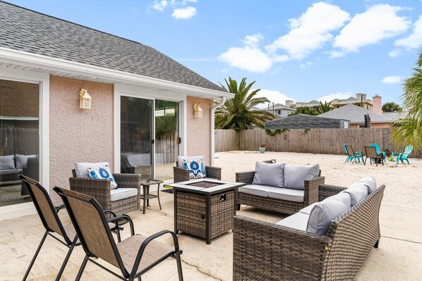 Large, private backyard. Comfy seating and a fire table and fire pit, plus grill