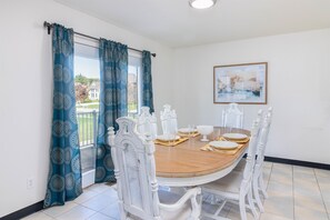 The dining area, an epitome of elegance and sophistication, perfectly accommodates a grand table set for six.