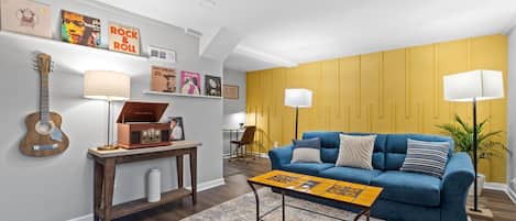 Cozy living room area with blue pull out couch, and a Talavera tile coffee table