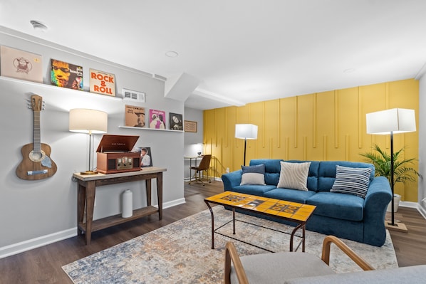 Cozy living room area with blue pull out couch, and a Talavera tile coffee table