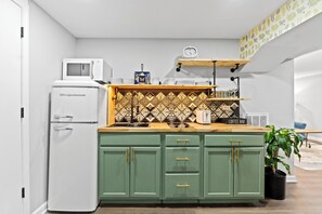 Kitchen with a beautiful Talavera backsplash and retro refrigerator. 