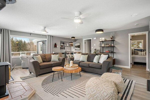 Living room with a wood-burning fireplace, board games, a Smart TV, cozy seating & more. There's also a single rollaway cot (with bedding) for additional sleeping space.