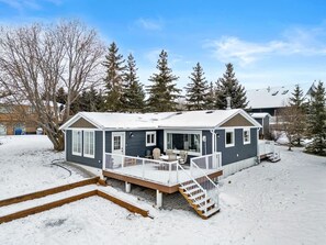 Exterior of Sunnyside Cove with outdoor seating & a fire pit.
