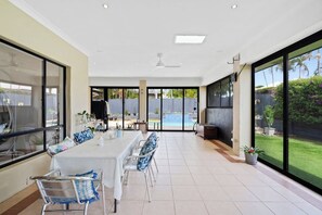 The covered patio can be enjoyed all year round. There’s large alfresco seating and sliding doors to the garden.