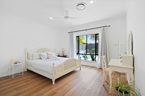  Sleep easy in the primary bedroom. It highlights a king-sized bed and dressing table which doubles as a workspace.
