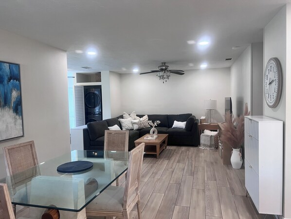 Open concept Living and Dining area with hidden washer and dryer near back door
