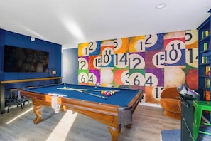Pool table, dart board and Karaoke game room with a large TV and plenty of seating