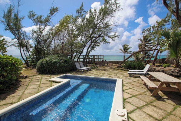 View from the covered verandah of the pool and gardens