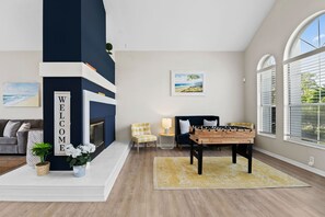 Two comfortable living spaces with expansive windows and plush seating, perfect for relaxation and gathering.