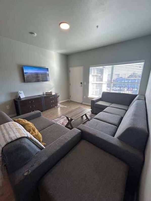 Relax in our spacious living room, complete with smart TV & comfy seating.