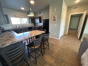 Granite counters & stainless appliances highlight our fully equipped kitchen.