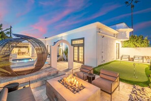 Fire pit lounge with plenty of seating plus 4-hole custom putting green 