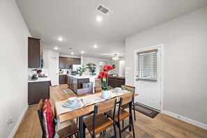 Spacious dining table that sits 6 with full tableware and silverware included.