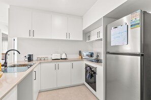 Full kitchen well out fitted for your stay. Full sized fridge, microwave, Nespresso coffee maker, toaster, kettle, and full sets of kitchenware