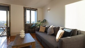 Relax in style! This bright living room features a cozy sofa, sunlit windows, and direct access to a charming balcony with stunning Douro River views.
#CozyWithAView #DouroRiverside #PortoLiving