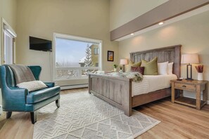 Primary Bedroom with Ensuite on main floor.  Private door to the upper deck, walk-in closet, flatscreen tv, views of Breckenridge Resort.