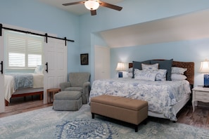 Primary Bedroom with Smart TV, attached bathroom & additional sleeping area