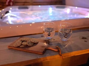 Enjoy your stay with the home's private hot tub with wine and chocolate chips.