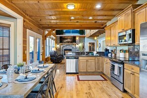 Enjoy the gourmet kitchen while onlookers sit at the bar or the large table.
