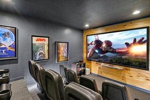 Enjoy this 4K Ultra movie theater room with surround sound and seating for 12.