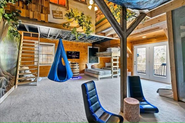 Enjoy this one-of-a-kind indoor treehouse with games, rock-climb wall & top loft